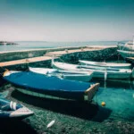 A group of boats docked in the water.