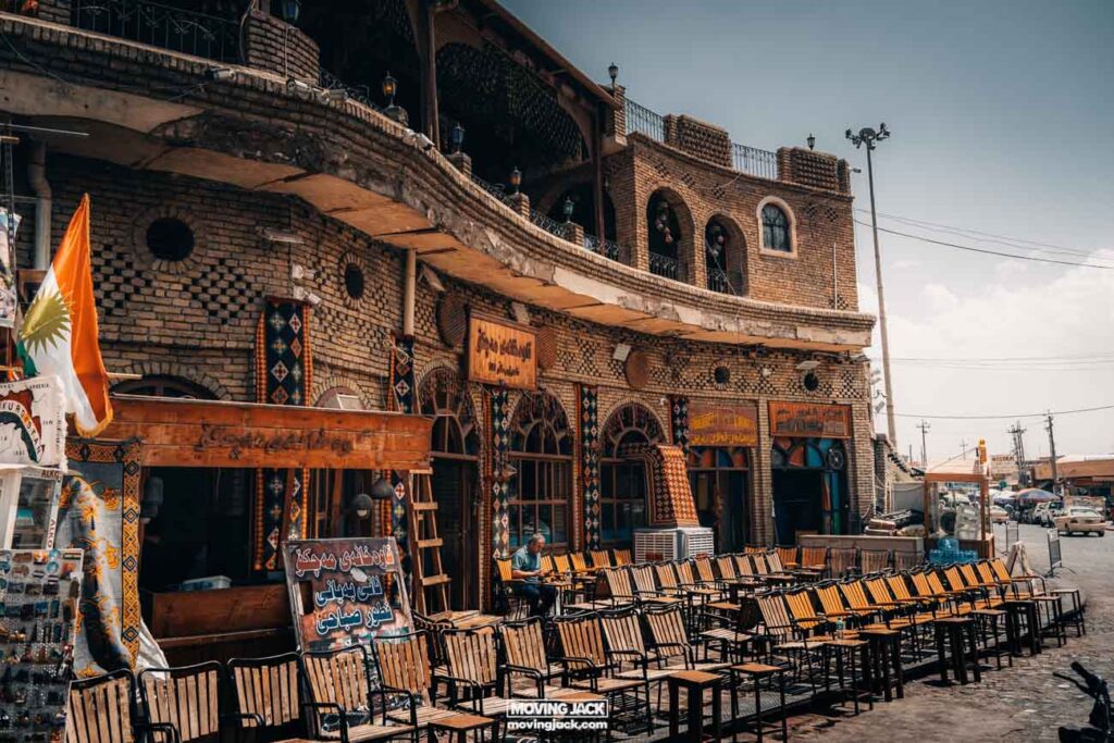 Erbil citadel and grand qaysari bazaar · complete guide 2025 13 erbil citadel A street scene with chairs and tables in front of erbil citadel.