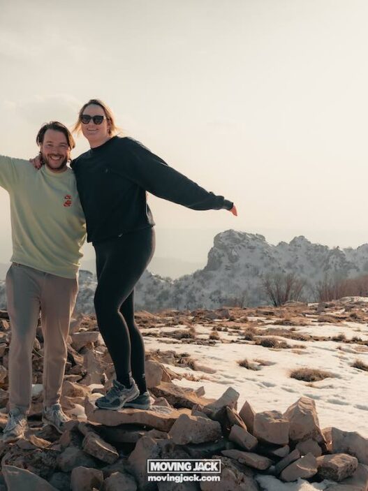 Moving abroad as a couple: pros, challenges & relationship tips 14 moving to south korea with a cat Moving abroad as a couple, two people pose happily on a rocky, snowy hilltop with distant mountains in the background, embracing their shared adventure. -copyright-moving-jack. Com