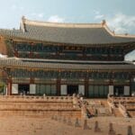 What to do in seoul: 13 unique things to do + what to skip! 8 ikseon dong Gyeongbokgung palace in seoul, south korea, with a mountain in the background and a clear sky above. -copyright-moving-jack. Com