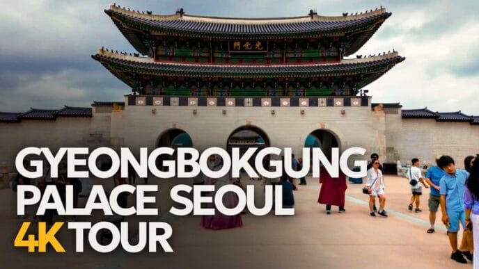People walk in front of the main gate of gyeongbokgung palace in seoul, with a large tour text overlay in the foreground. -copyright-moving-jack. Com