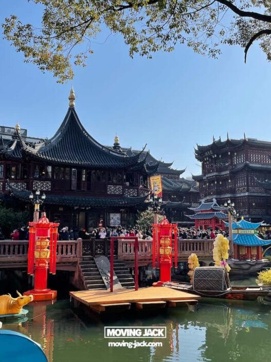 Is yu garden worth visiting in 2025? Complete guide & honest local review 52 renting a car in okinawa Traditional chinese architecture surrounds a pond with red lanterns, statues, and a wooden bridge crowded with people under a clear blue sky, making yu garden worth visiting for its vibrant atmosphere and cultural beauty. -copyright-moving-jack. Com