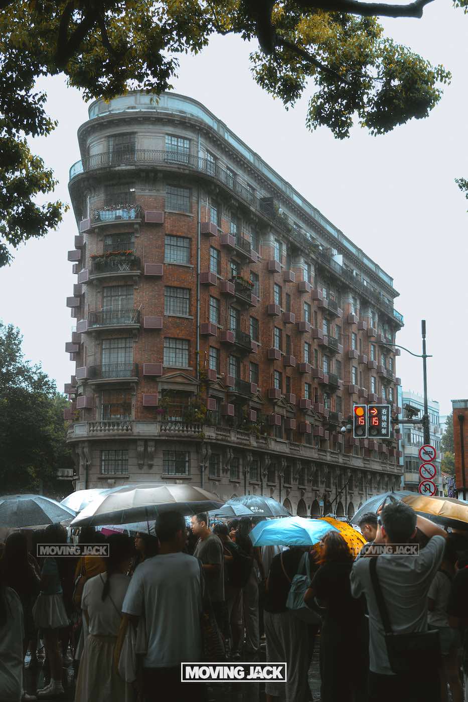 57 things to do in shanghai: the ultimate handbook 19 things to do in shanghai A crowd with umbrellas waits at a crosswalk in front of wukang mansion's historic red-brick building in shanghai's french concession on a cloudy day—one of the classic sights among things to do in shanghai. -copyright-moving-jack. Com