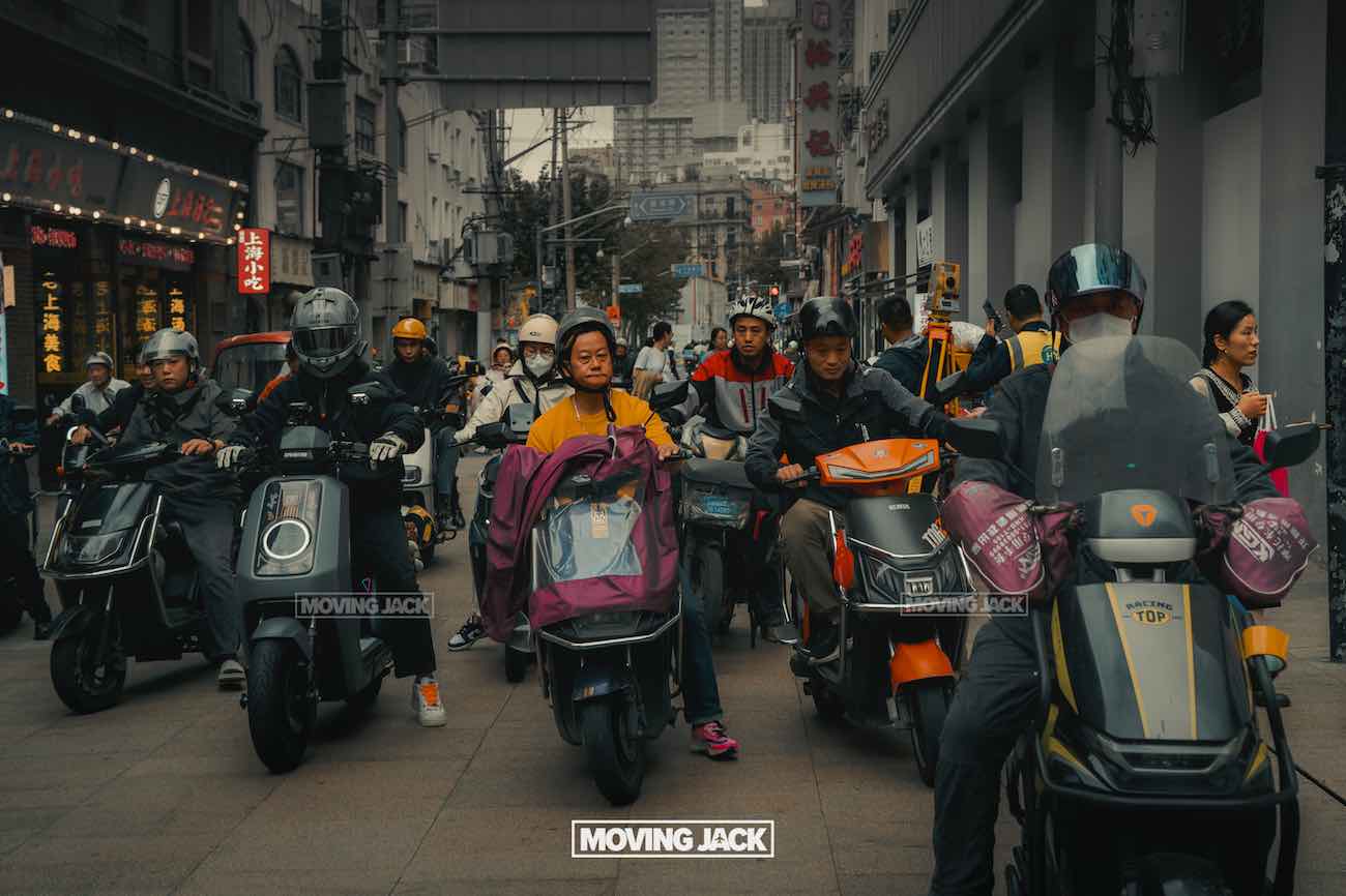 57 things to do in shanghai: the ultimate handbook 36 things to do in shanghai A group of people on electric scooters waits in a crowded urban street in shanghai, surrounded by buildings and pedestrians on a cloudy day—showing the local transportation and street life things to do in shanghai that capture the city's everyday energy. -copyright-moving-jack. Com