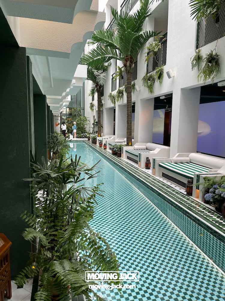 57 things to do in shanghai: the ultimate handbook 45 things to do in shanghai A narrow indoor pool with a blue and white checkered tile floor, lined with palm trees, green plants, and white lounge seating—an inviting retreat among the many things to do in shanghai. -copyright-moving-jack. Com