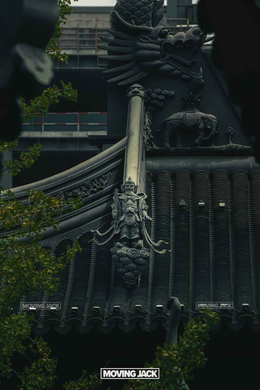 57 things to do in shanghai: the ultimate handbook 38 things to do in shanghai Ornate statue and detailed carvings adorn the dark rooftop of a traditional temple building at jing'an temple, partially framed by leafy branches with a modern structure in the background—showing the architectural contrast that makes visiting spiritual sites among the top things to do in shanghai. -copyright-moving-jack. Com