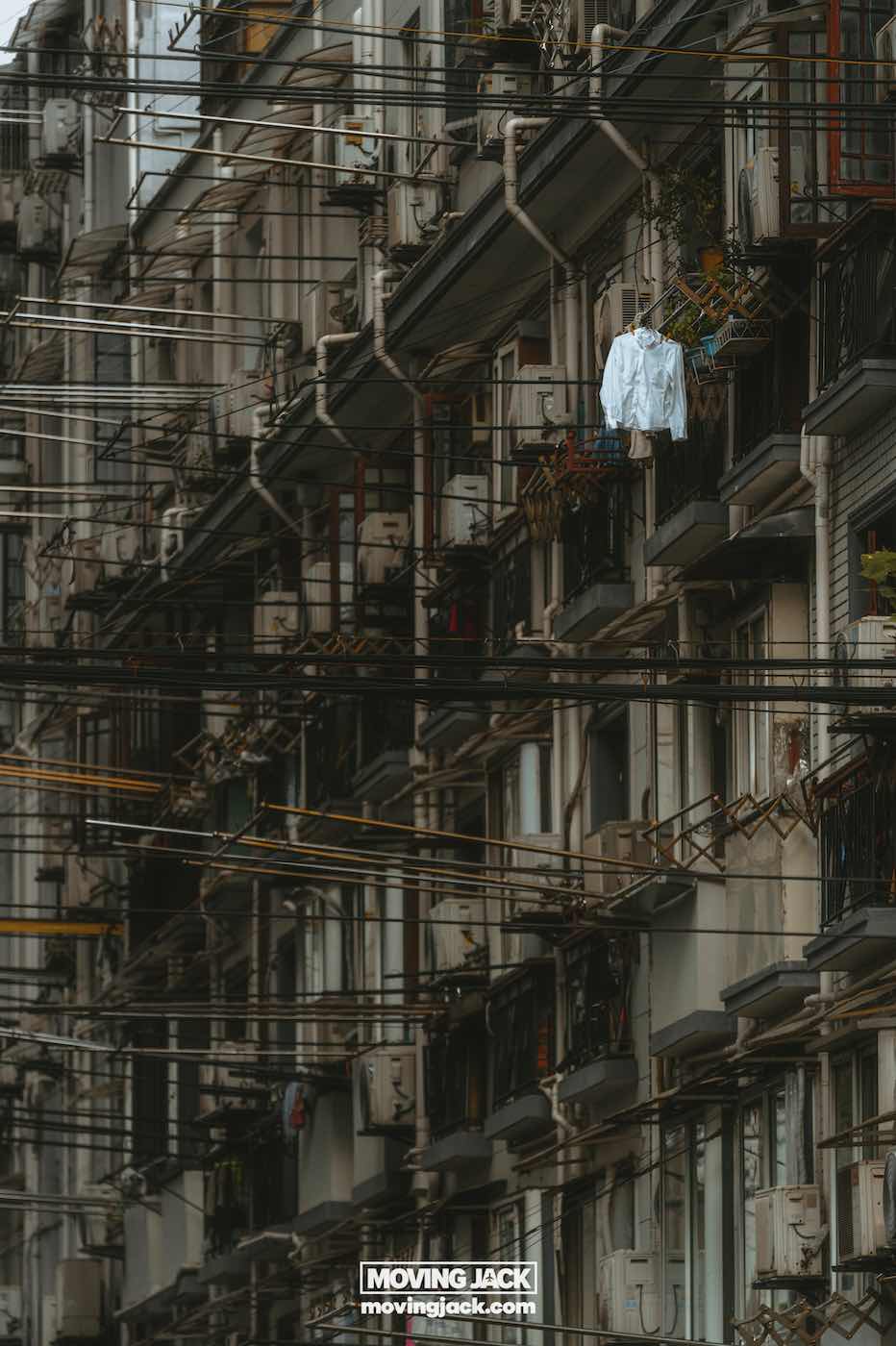 15 unique things to do in shanghai near the bund 11 things to do in shanghai near the bund A row of apartment balconies with pipes and wires overhead; a white shirt hangs on one balcony railing. -copyright-moving-jack. Com
