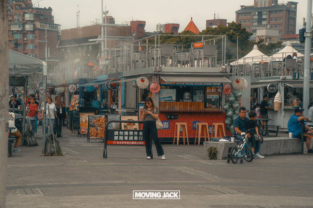 20+ best things to do in taipei (by an expert) 14 things to do in taipei A lively outdoor market scene—one of the best things to do in taipei—with food stalls, people strolling, a woman using her phone, and a child riding a bicycle. Urban buildings and signage bustle in the background. -copyright-moving-jack. Com