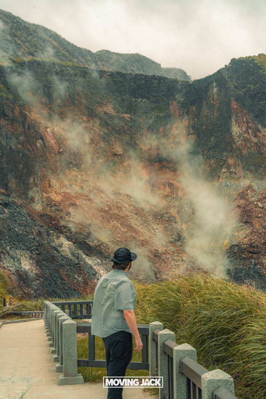 20+ best things to do in taipei (by an expert) 7 things to do in taipei A person stands on a pathway, looking at a steaming, rocky mountainside with sparse grass and cloudy skies above. The scene appears geothermal and rugged. -copyright-moving-jack. Com