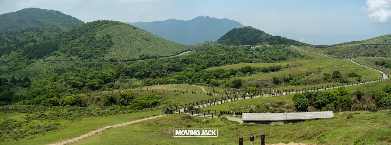 20+ best things to do in taipei (by an expert) 5 things to do in taipei Panoramic view of lush green hills under a blue sky with distant mountains, wooden fences winding through grassy fields, and a small structure in the foreground. -copyright-moving-jack. Com