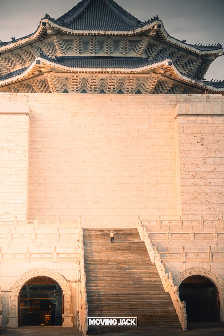 20+ best things to do in taipei (by an expert) 11 things to do in taipei A person stands alone on wide stone steps leading up to a large traditional east asian building with ornate roof details, bathed in warm sunlight. The photo has a grand and symmetrical composition. -copyright-moving-jack. Com