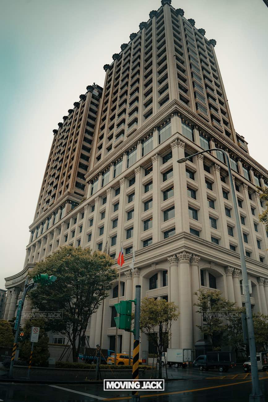 20+ best things to do in taipei (by an expert) 44 things to do in taipei Tall, ornate beige building with classical architectural details on a city street corner, trees lining the sidewalk, and traffic lights visible; overcast sky above. -copyright-moving-jack. Com