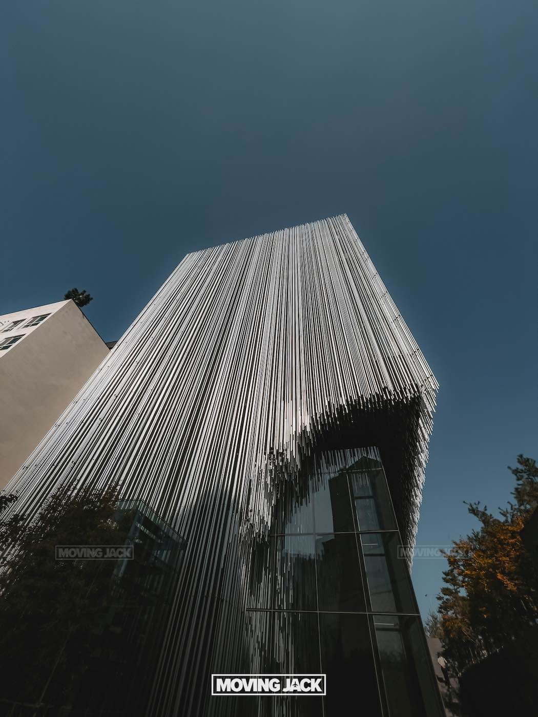 31 best free & cheap things to do in seoul (by an expert) 44 free things to do in seoul A modern building with vertical metal rods covering its facade, photographed from a low angle against a clear blue sky—an architectural gem and one of the free things to do in seoul for design lovers. -copyright-moving-jack. Com