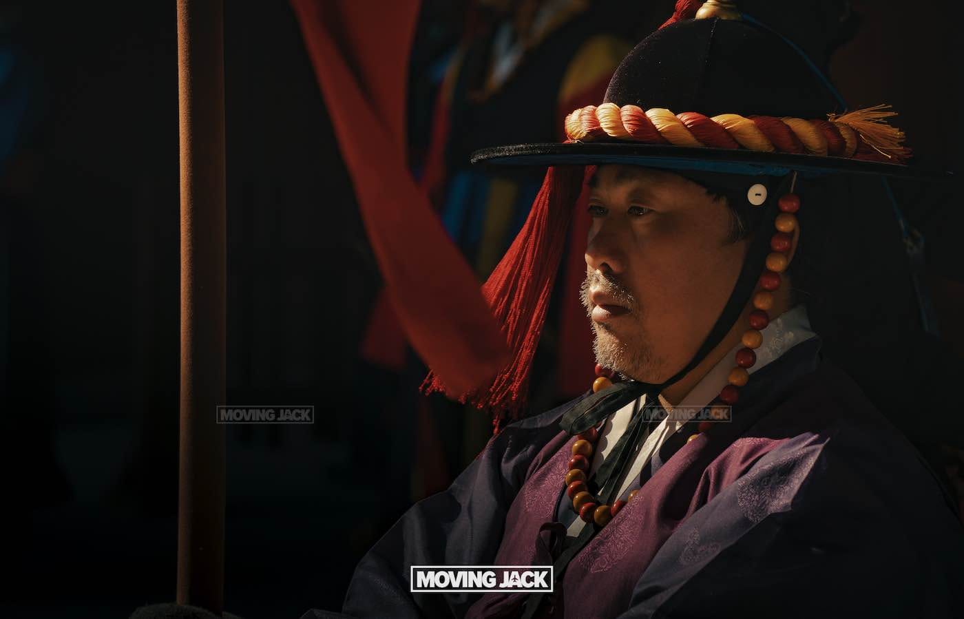 31 best free & cheap things to do in seoul (by an expert) 7 free things to do in seoul A man in traditional korean attire and a beaded hat sits in profile, illuminated by sunlight against a dark background—capturing the spirit of free things to do in seoul, like exploring its rich cultural heritage. -copyright-moving-jack. Com