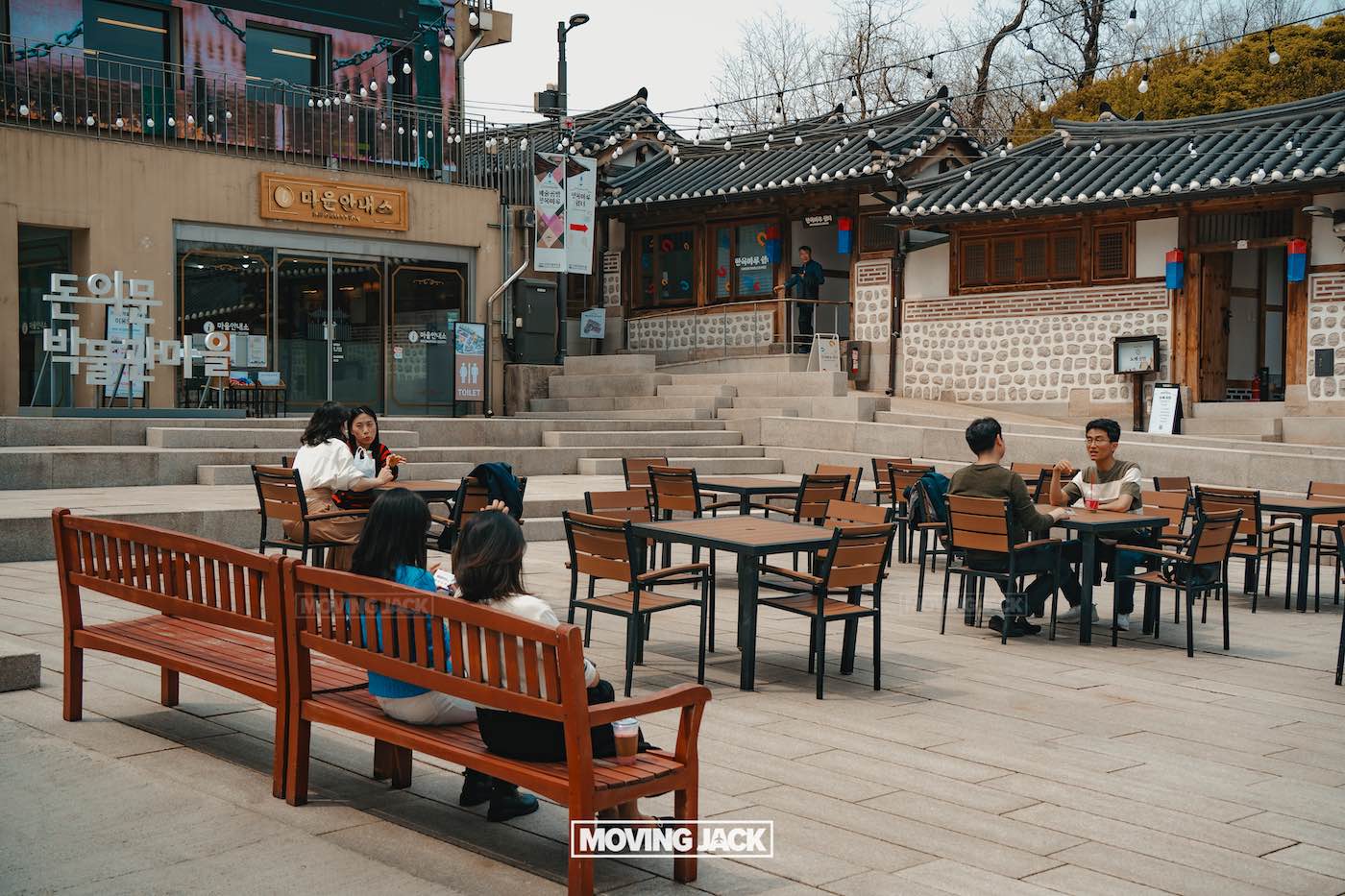 31 best free & cheap things to do in seoul (by an expert) 17 free things to do in seoul People sit and talk at outdoor tables and benches in a courtyard surrounded by traditional korean buildings and shops, enjoying one of the free things to do in seoul. -copyright-moving-jack. Com