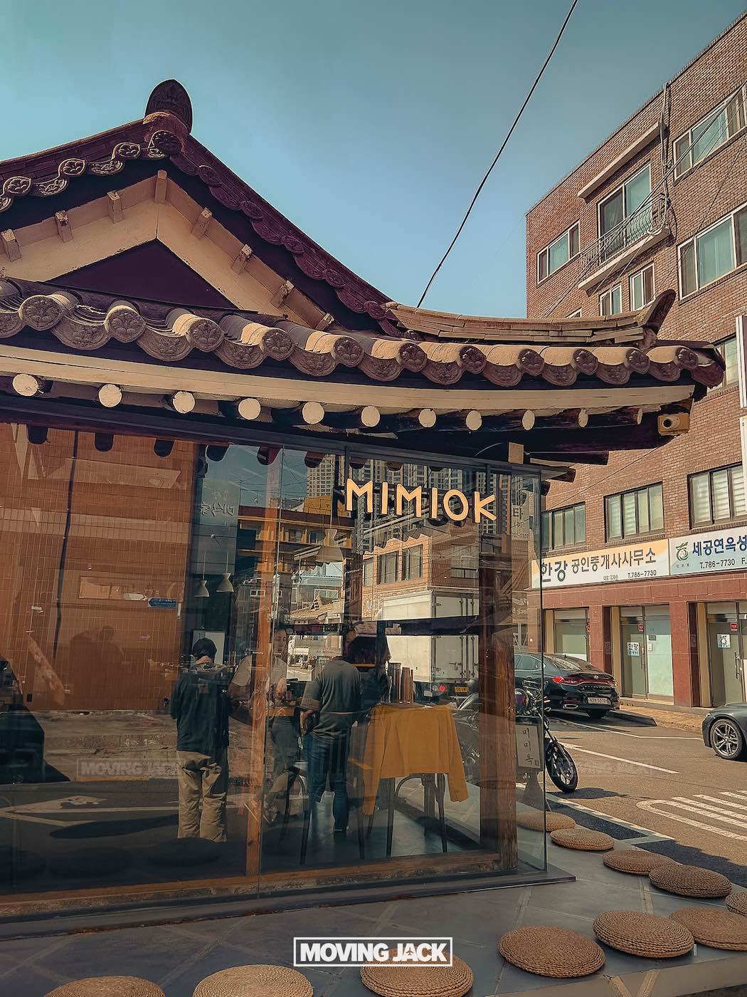 31 best free & cheap things to do in seoul (by an expert) 20 free things to do in seoul A traditional-style building with glass walls and the sign "mimiok" stands on a street with cars and modern buildings in the background, offering a glimpse into local culture and one of the free things to do in seoul. -copyright-moving-jack. Com