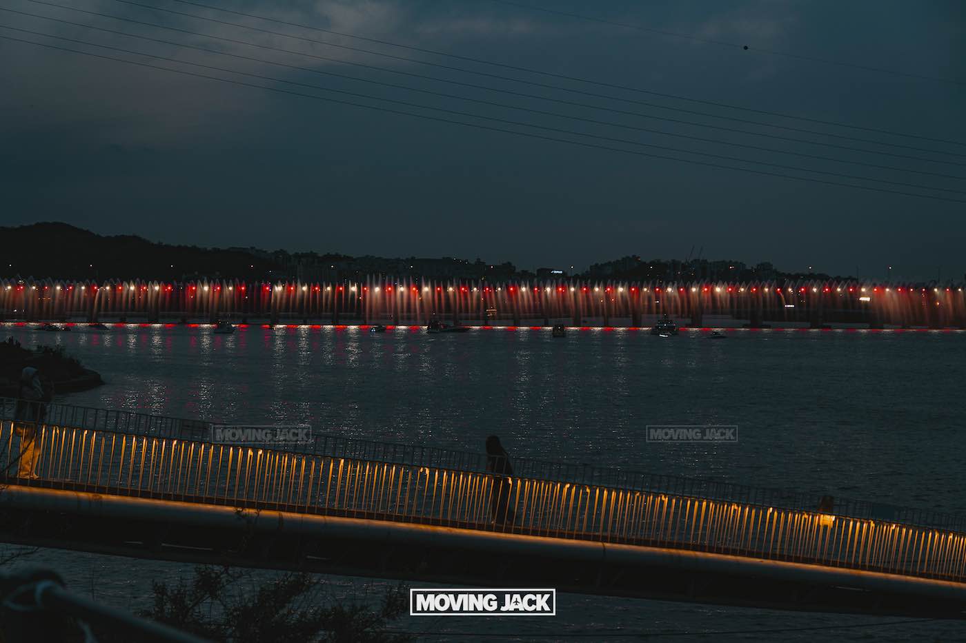 31 best free & cheap things to do in seoul (by an expert) 33 free things to do in seoul A brightly lit bridge crosses a river at night in seoul, with a distant illuminated structure and dark silhouettes of people and landscape—one of the many free things to do in seoul for an unforgettable evening. -copyright-moving-jack. Com