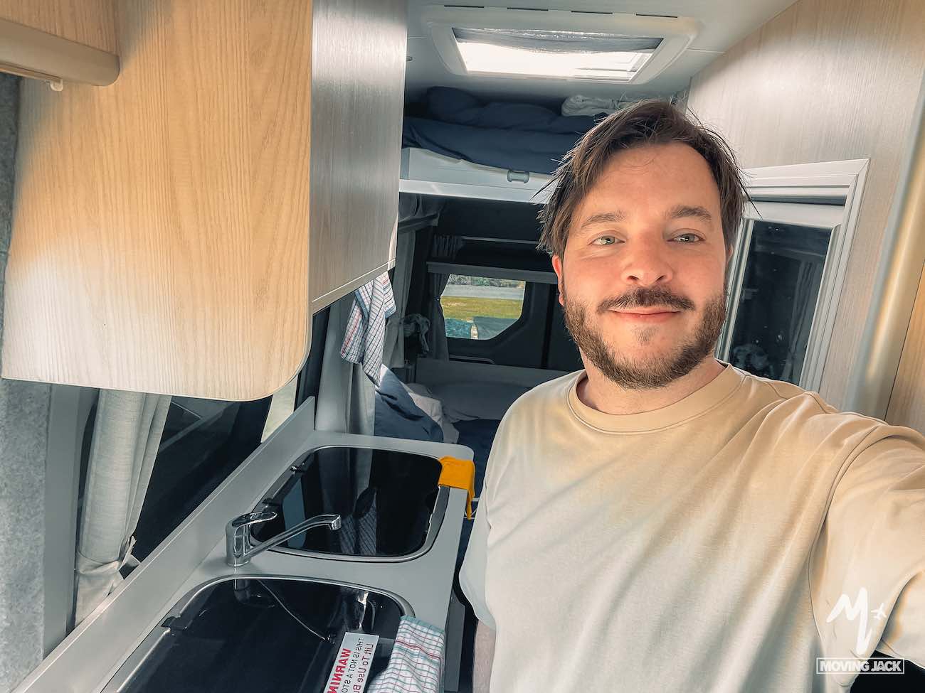 Chris taking a selfie inside a camper van.