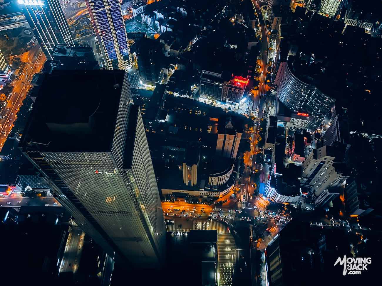 Luchtfoto van een stad 's nachts met verlichte straten en hoge wolkenkrabbers, helder verlichte gebouwen – perfect om te ontdekken waar je in Changsha kunt verblijven.